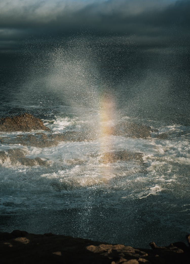 Rainbow On Waves Crushing On Sea Shore