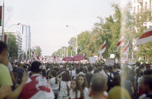 People with Flags in a City 