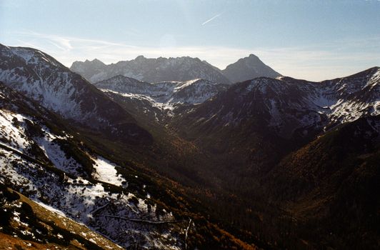 A stunning view of snow-capped mountains under a clear blue sky, perfect for nature lovers.