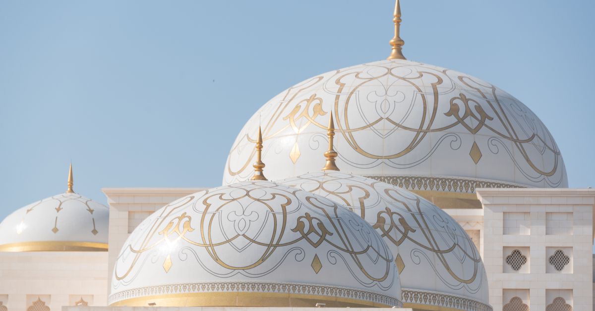 Captivating view of Qasr Al Watan's domes against a clear blue sky in Abu Dhabi, UAE.