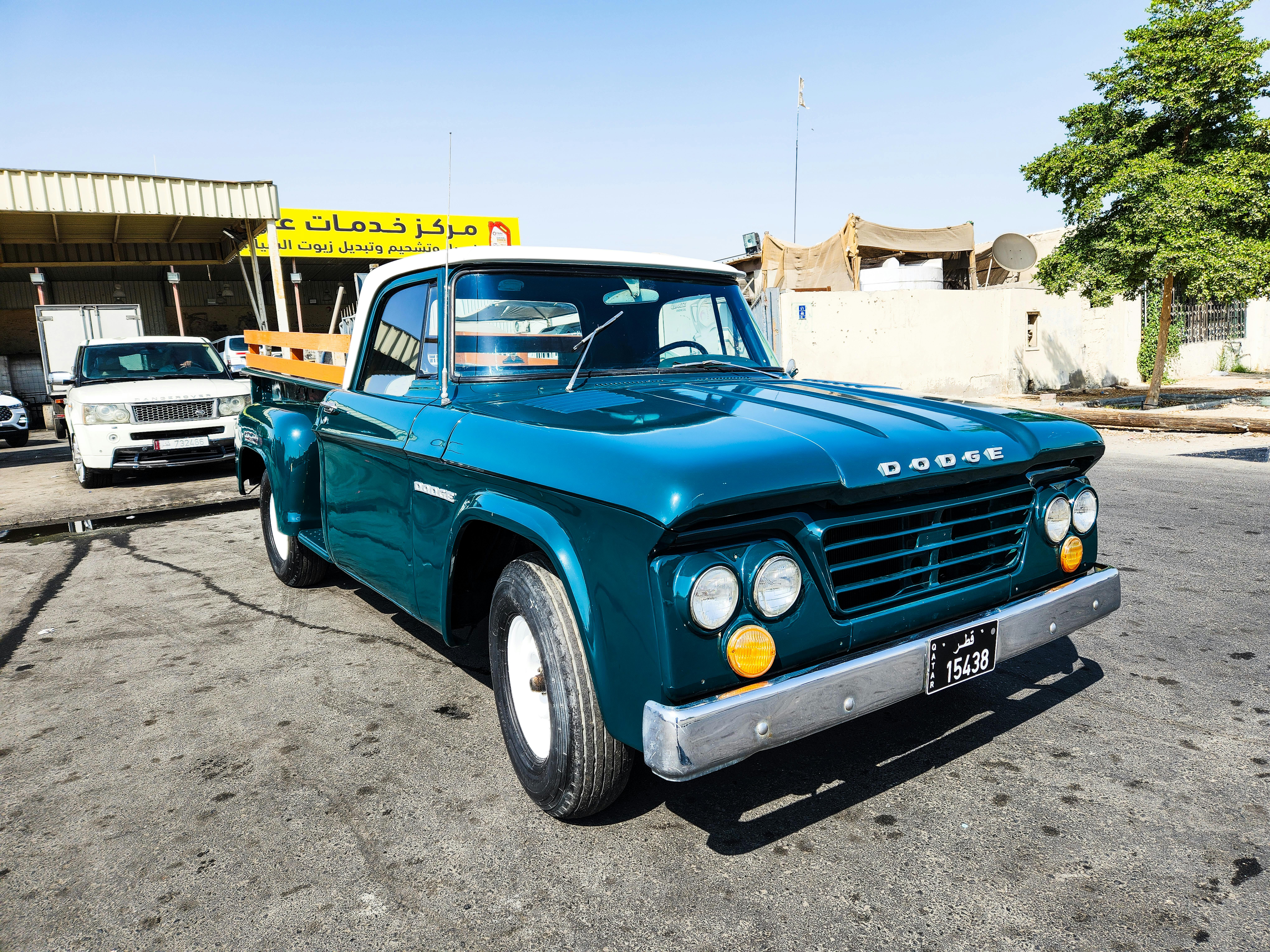 A pristine vintage Dodge pickup truck parked outdoors on a sunny day, showcasing classic automotive design.