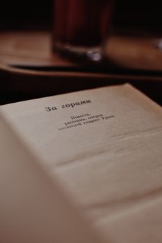 A detailed view of an open vintage book page with Cyrillic text in warm lighting. — photo by Darya Grey_Owl