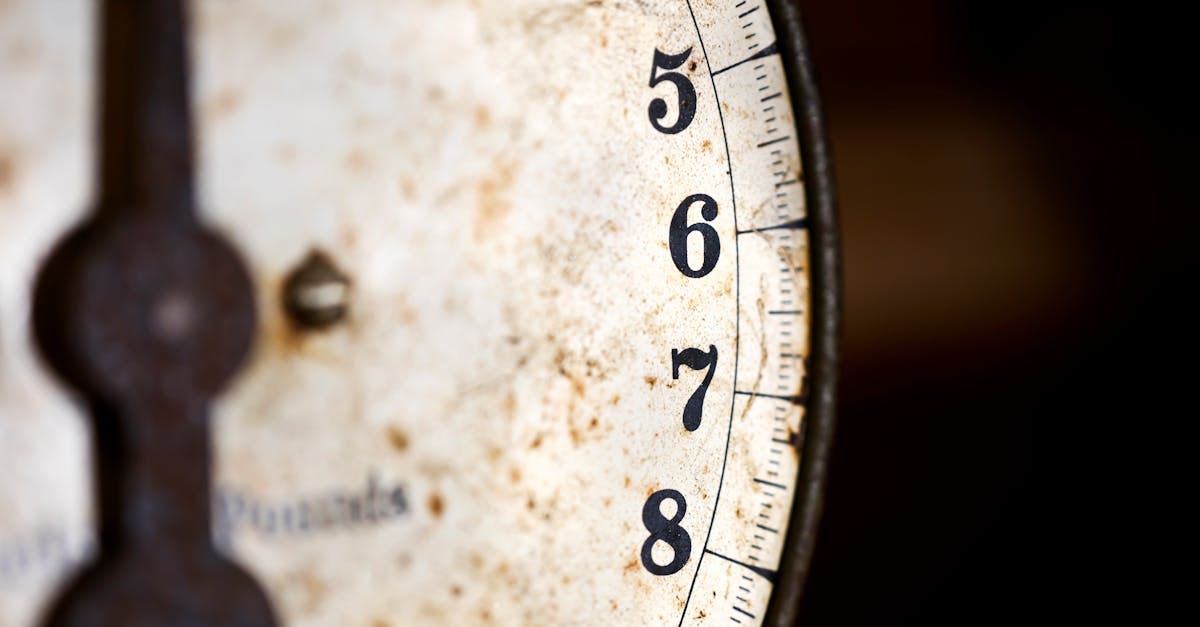 A detailed shot of an old and rusty analog scale with numbers visible.