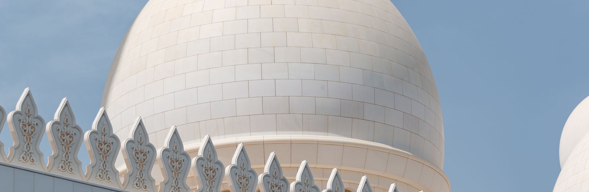 Close-up of the Sheikh Zayed Grand Mosque dome showcasing intricate Islamic architecture in UAE.
