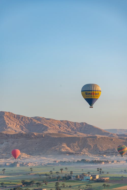 Hot Air Balloons Flying in Sky in Mountains Landscape