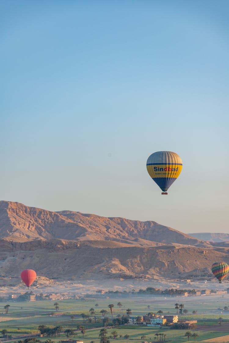 Hot Air Balloons Flying In Sky In Mountains Landscape