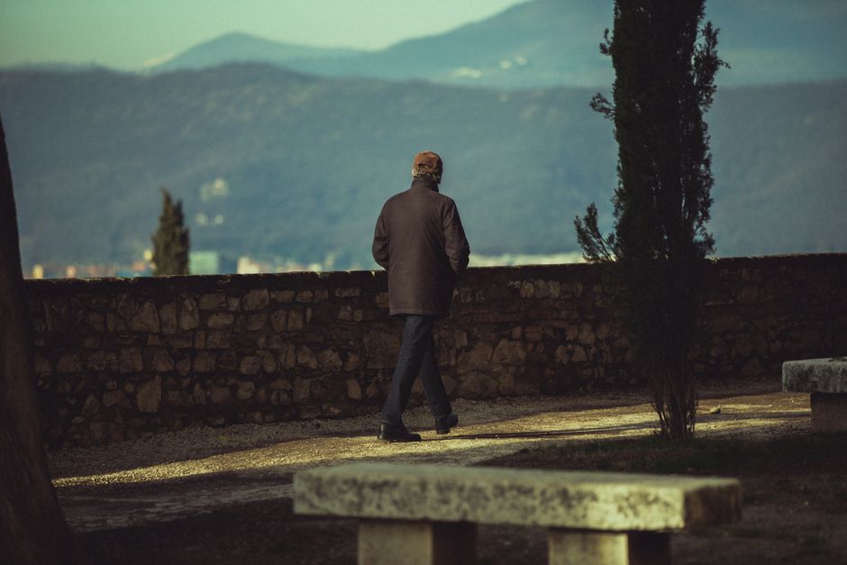 person walking bench skyline