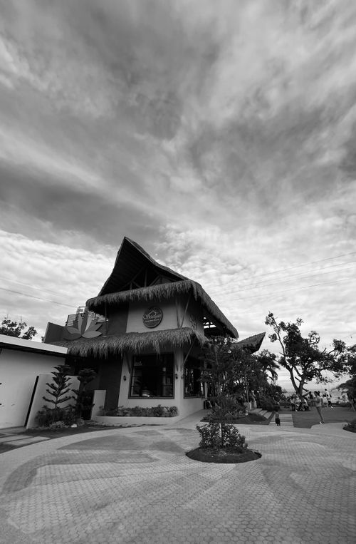 Free A black and white image of a thatched restaurant in Argao, showcasing tropical architecture. Stock Photo