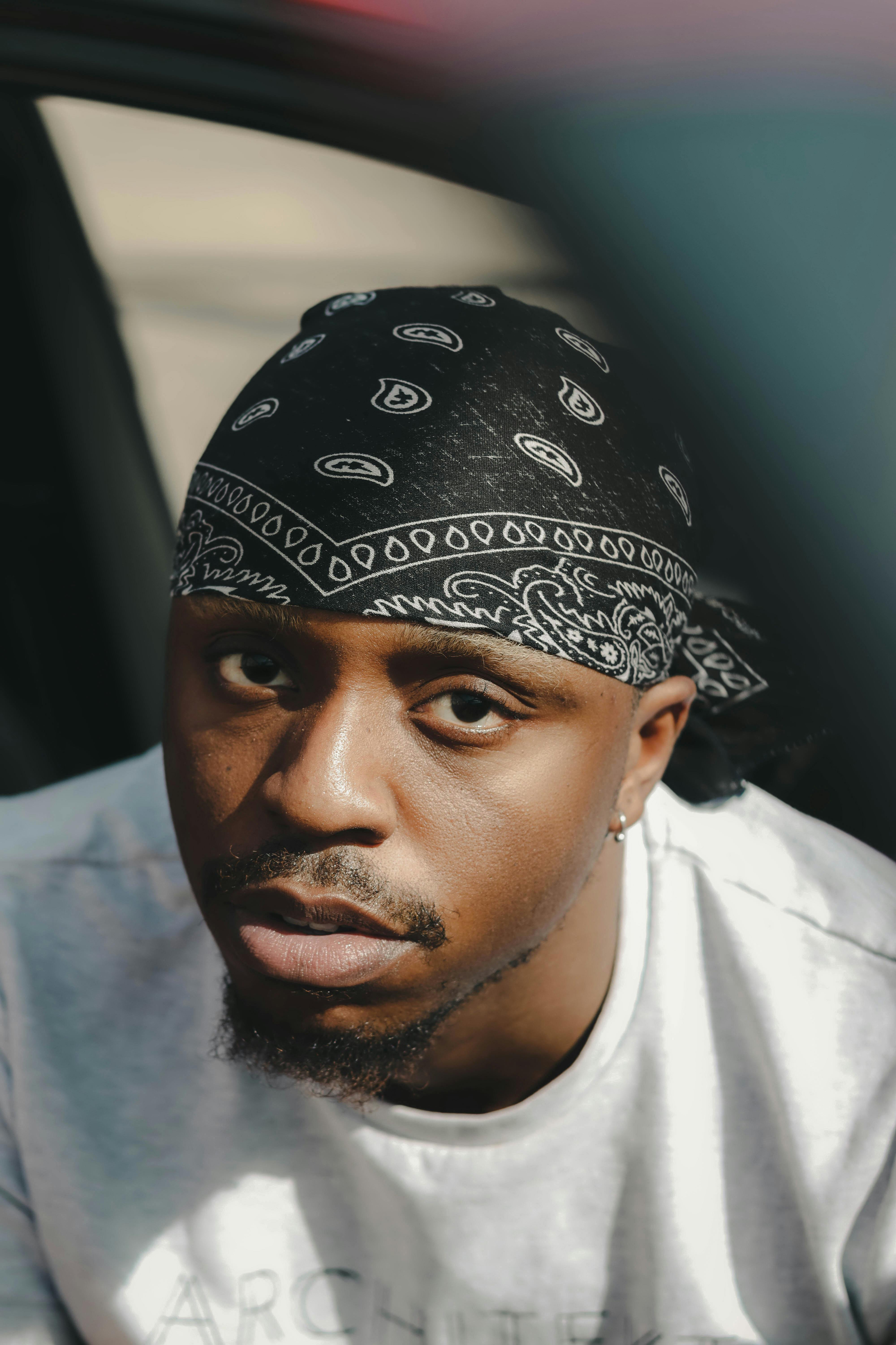 A Man Leaning Forward with His Hands Together · Free Stock Photo