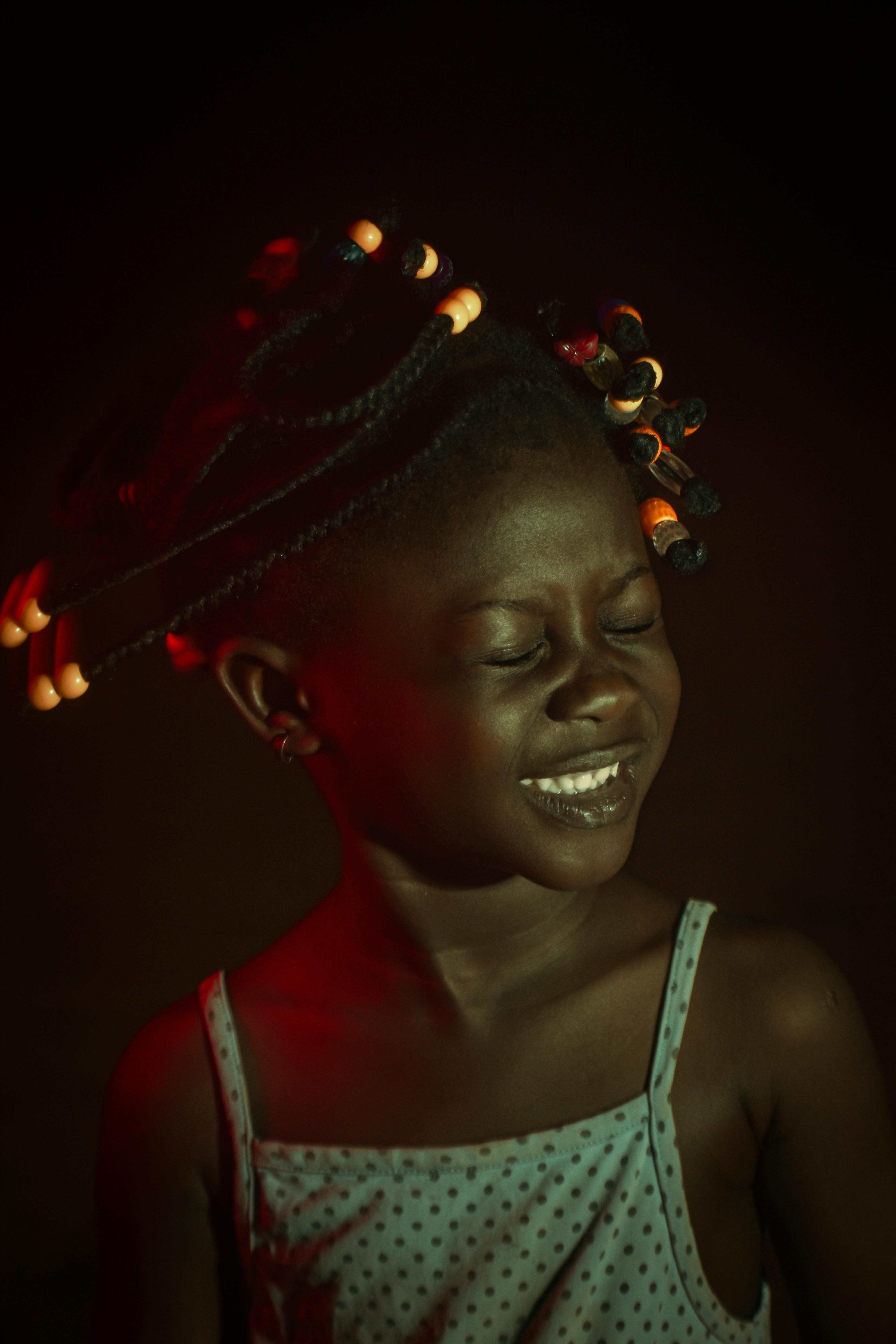 a girl with braided hair shaking her head