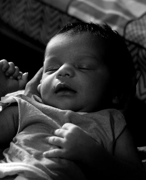 Grayscale Photo of a Sleeping Baby