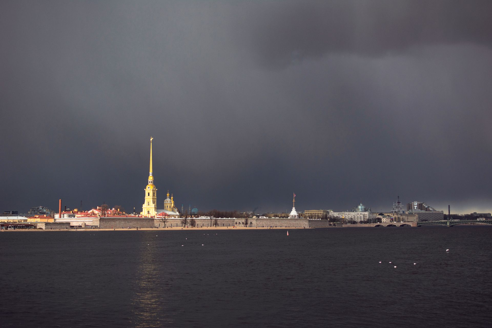 Dramatic view of St. Petersburg's skyline with storm clouds over the Peter and Paul Fortress.