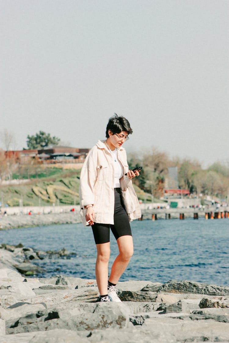 Woman Using Smartphone In Seaside