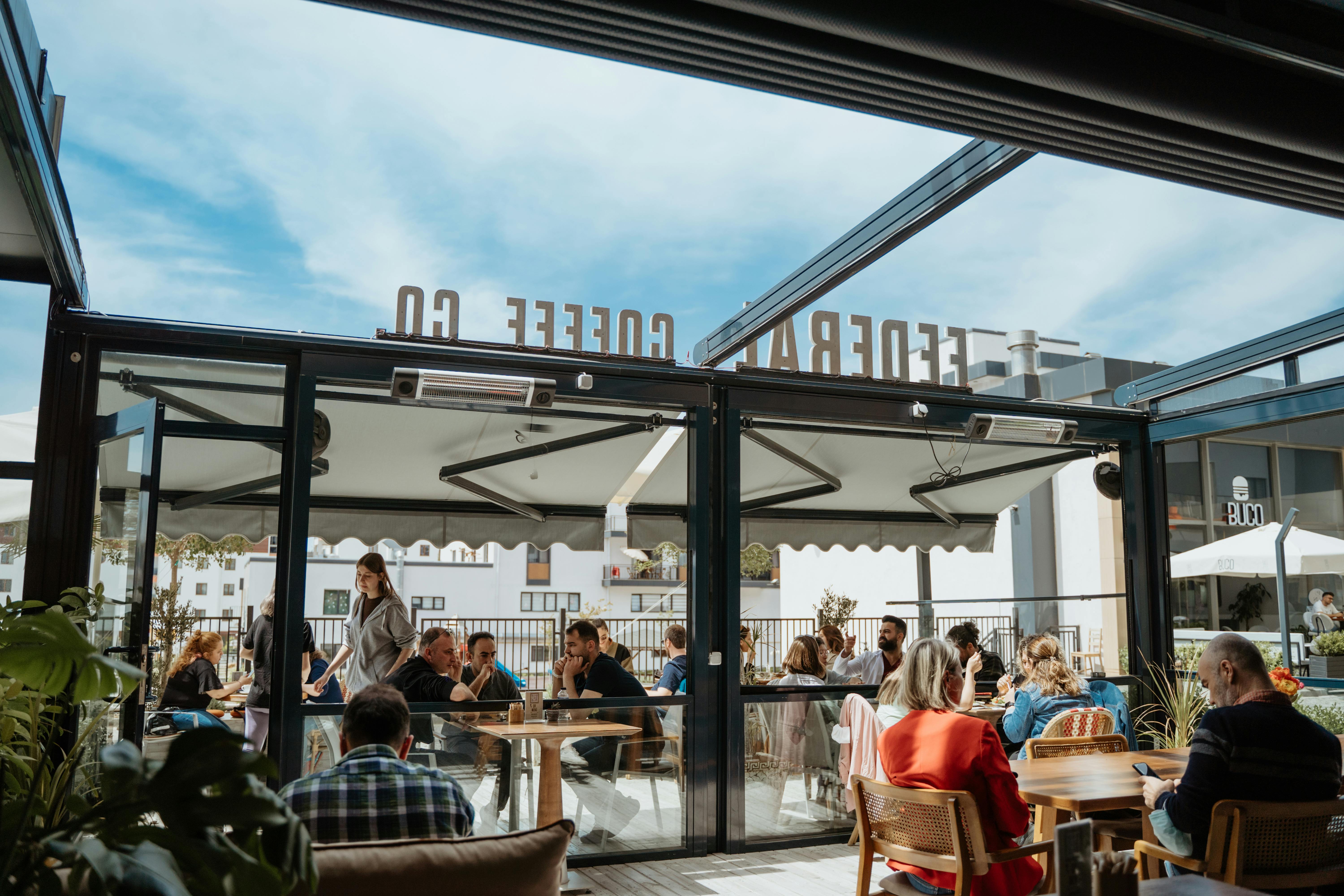 people enjoying an outdoor cafe on a sunny day in Capitol Hill - best neighborhoods to buy a home in capitol hill wa
