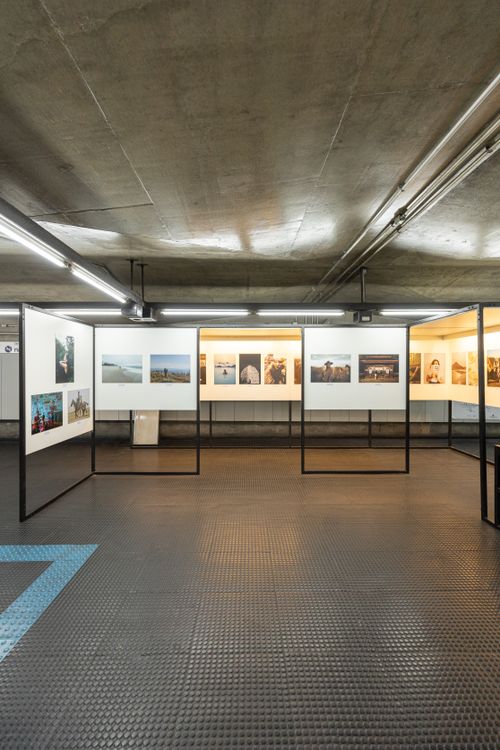 Free A serene view of art photographs displayed in a subway station exhibition. Stock Photo