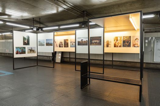 A photography display in a modern, illuminated underground station setting.