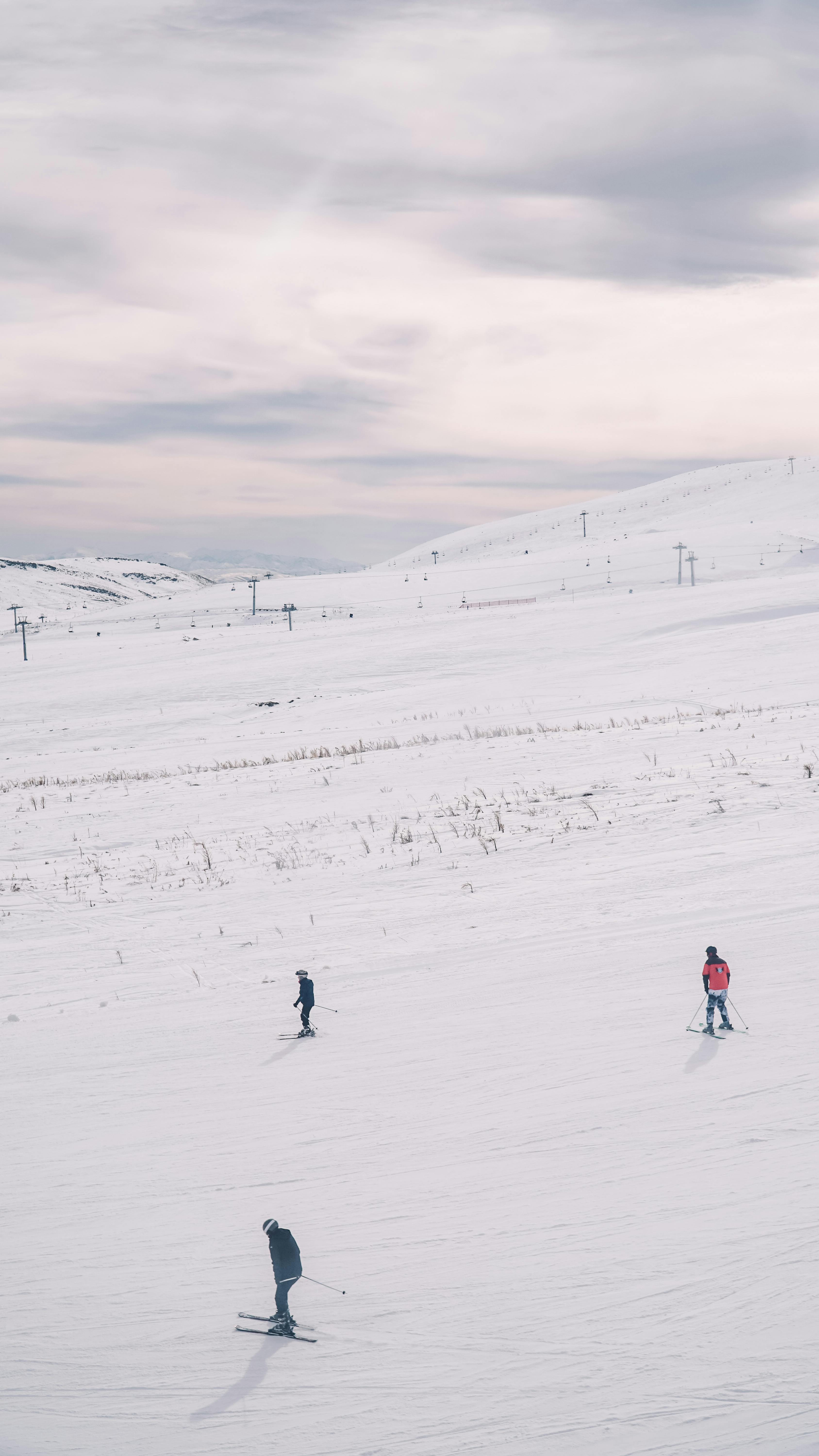 Prescription Goggle Inserts - Aerial view of skiers on a snow-covered mountain during a winter day.