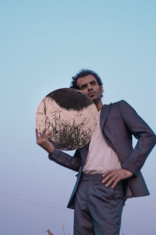 Man in Suit Posing with Mirror