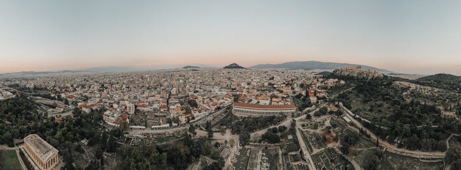 A stunning aerial view of Athens cityscape at sunrise, showcasing historical landmarks.