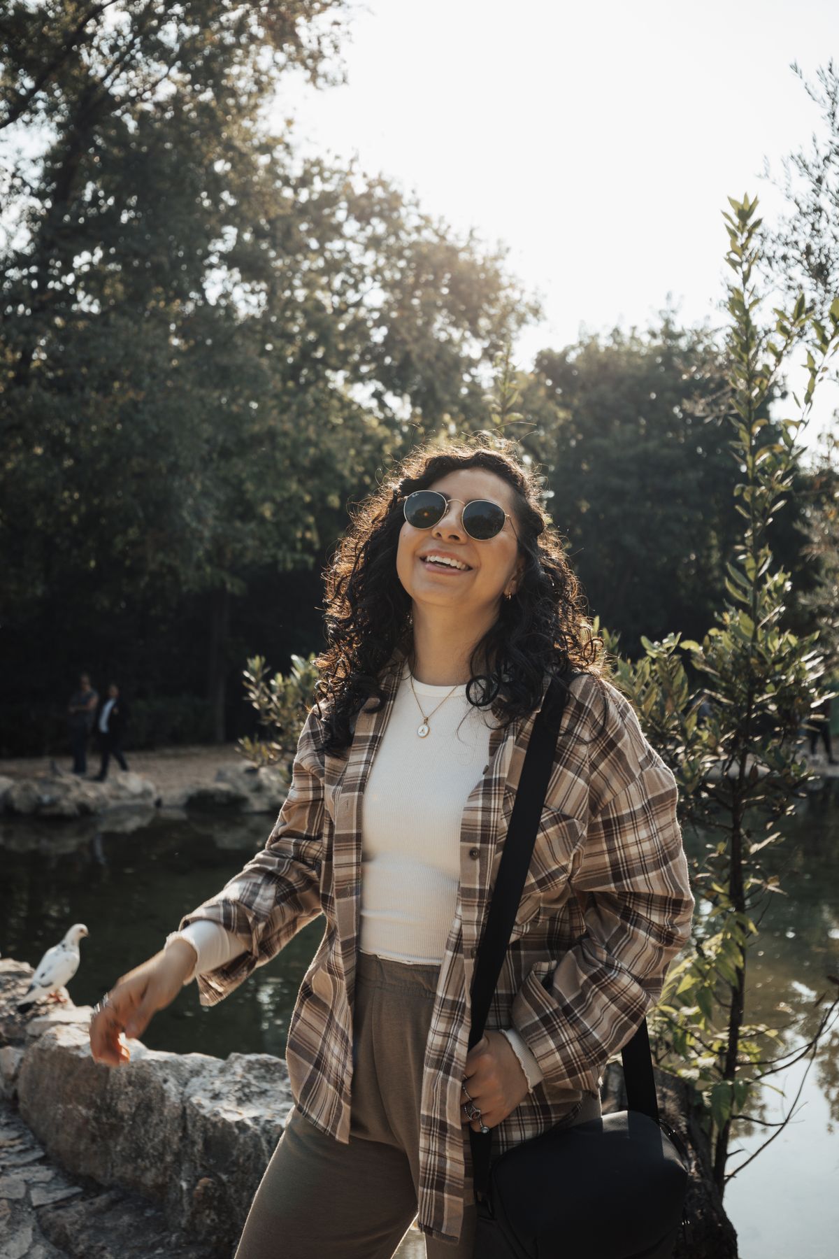 woman wearing a plaid flannel shirt with sunglasses for casual fall style