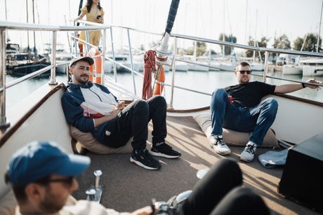 Friends relaxing on a boat deck at a marina &mdash; photo by Matheus Bertelli on Pexels