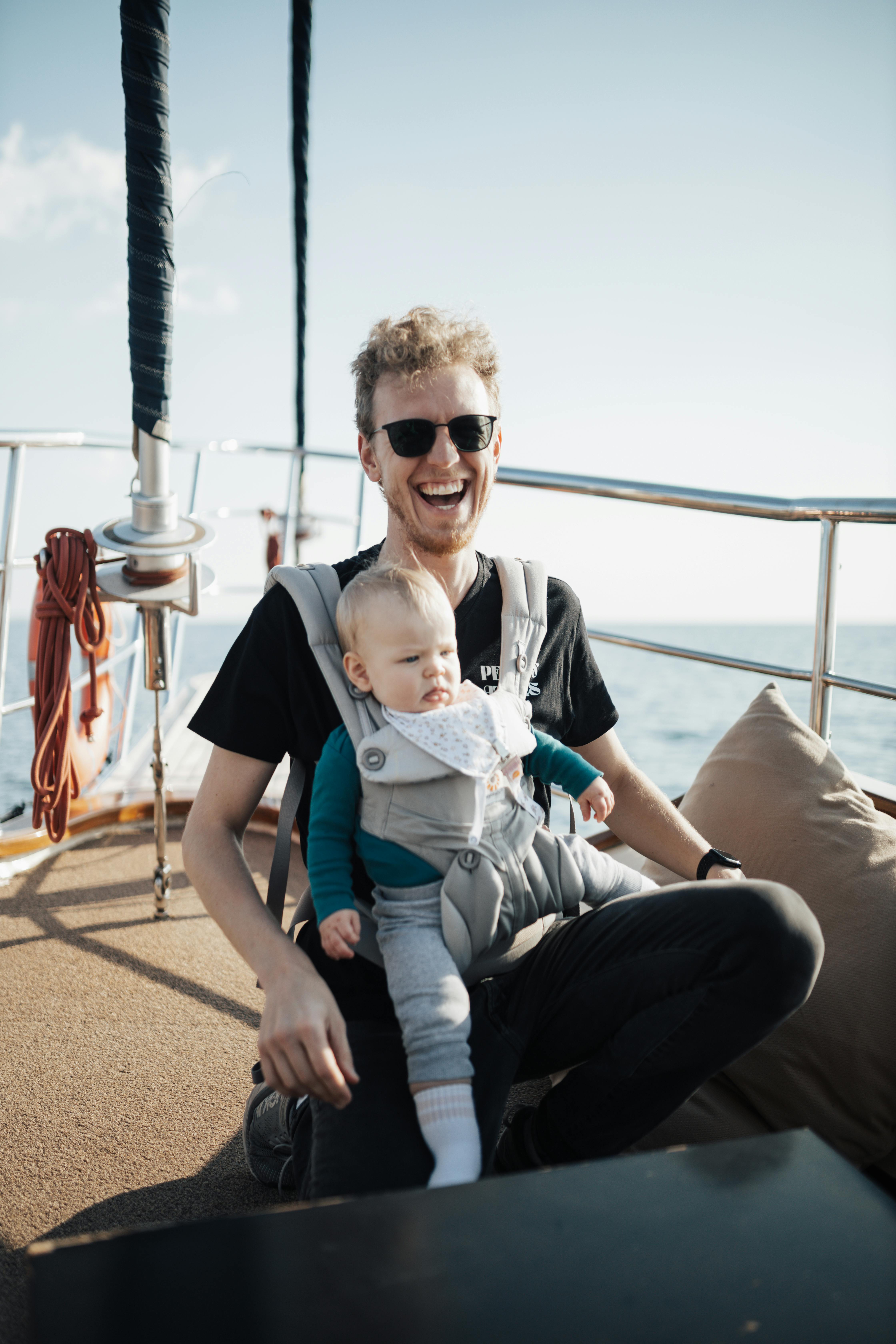 a man with a baby on a boat