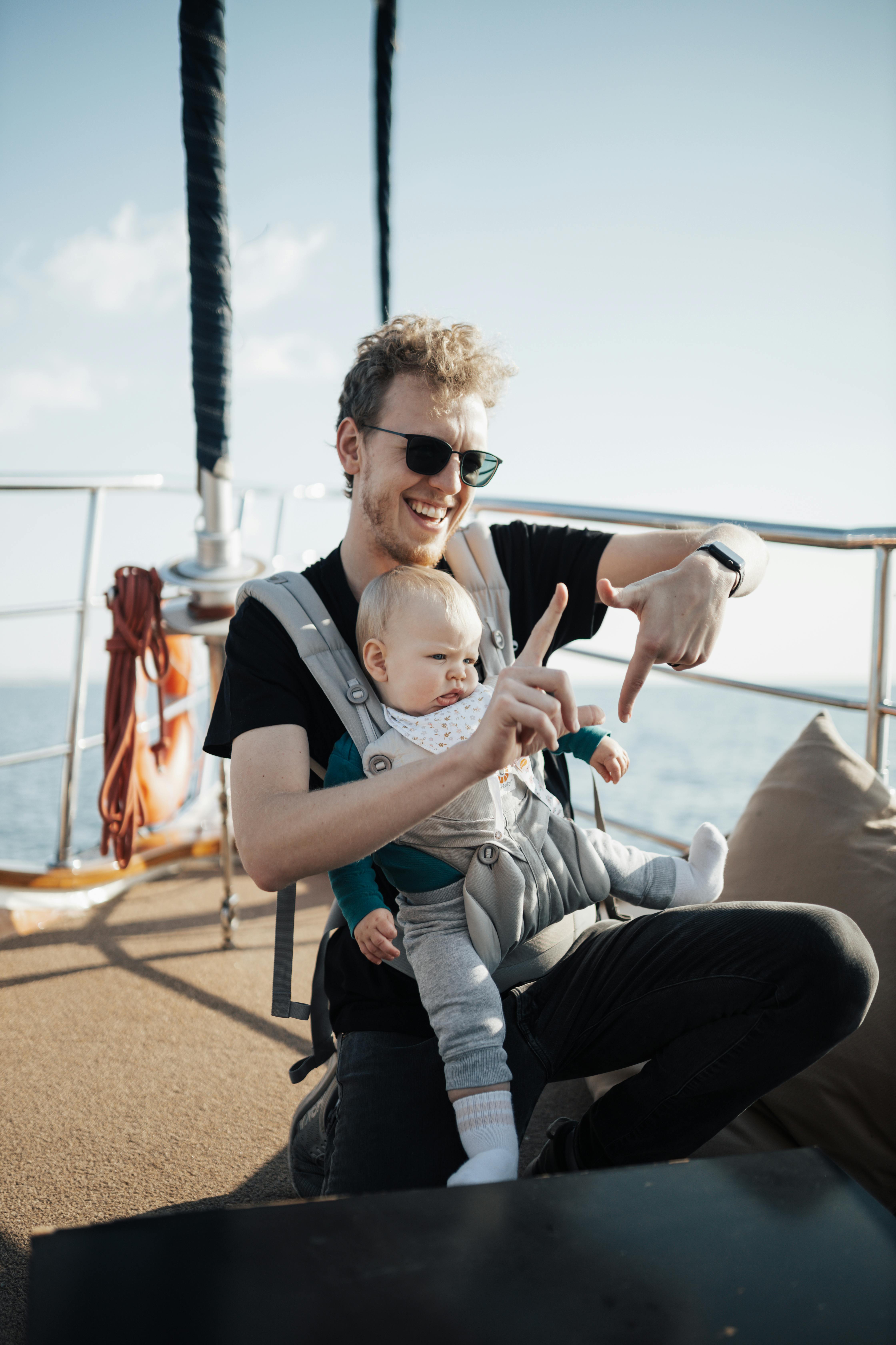 a man holding a baby on a boat