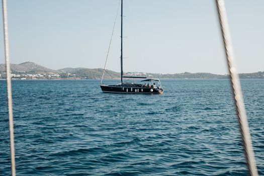 A luxury yacht sailing on calm blue sea under a clear sky, perfect for travel enthusiasts.