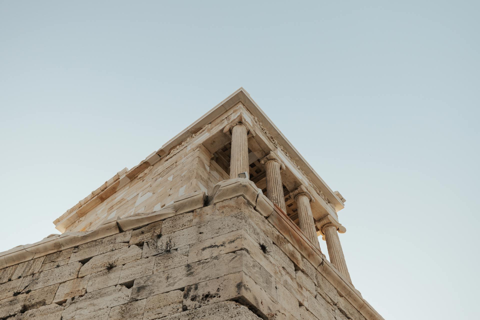 Photograph of ancient Greek temple architecture against a clear sky.