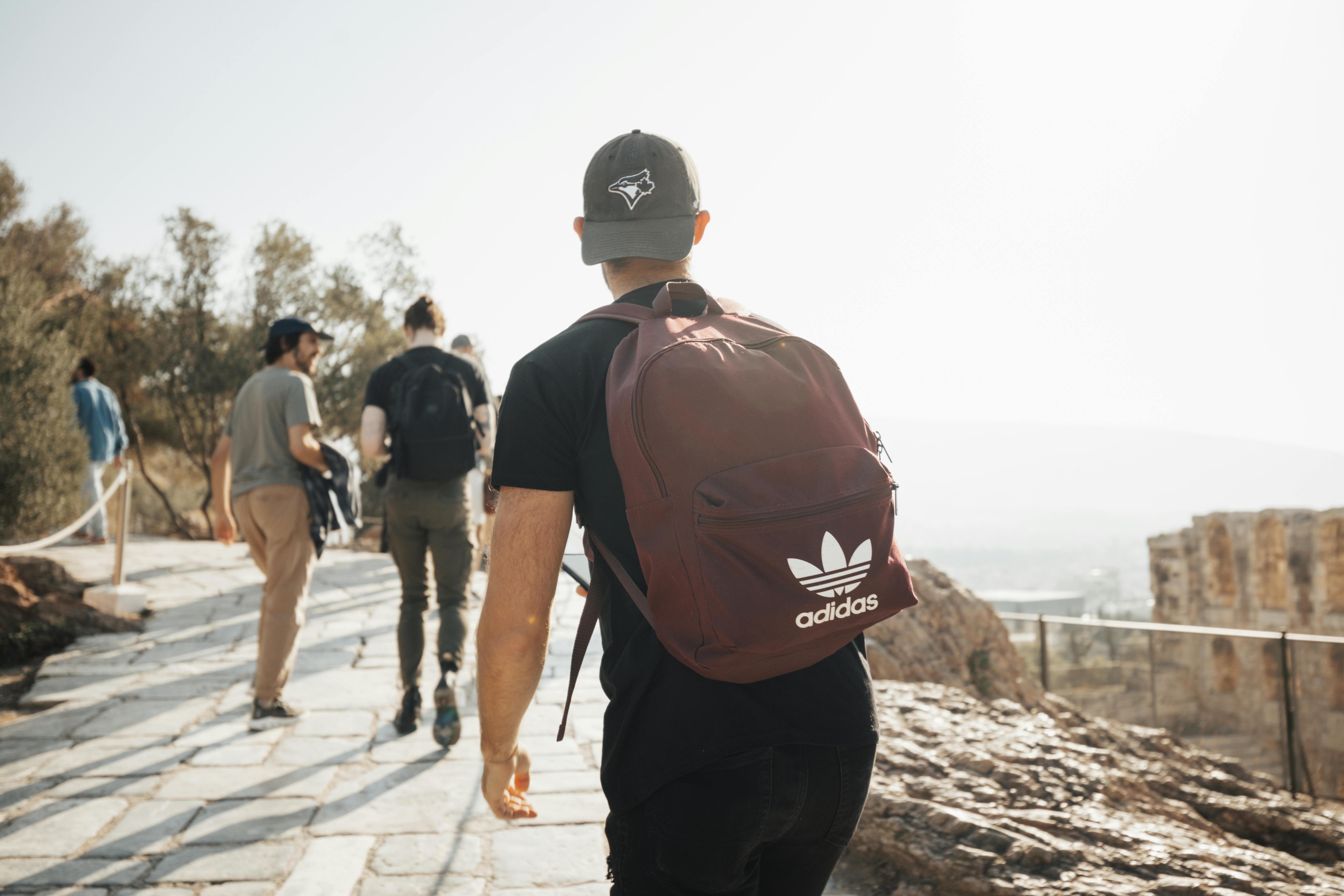 a man with a backpack walking down a path