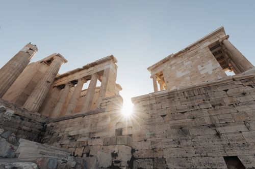 Free The ancient ruins of the Acropolis in Athens with a dramatic sunburst. Stock Photo