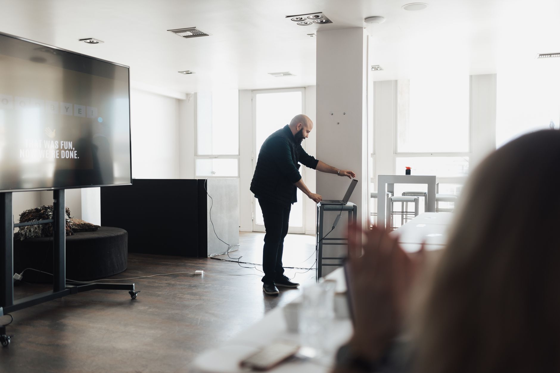 Professional presentation setting with a screen and laptop, captured indoors.