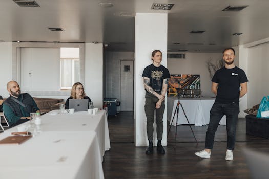 Casual team meeting with presentation in a modern office setting.