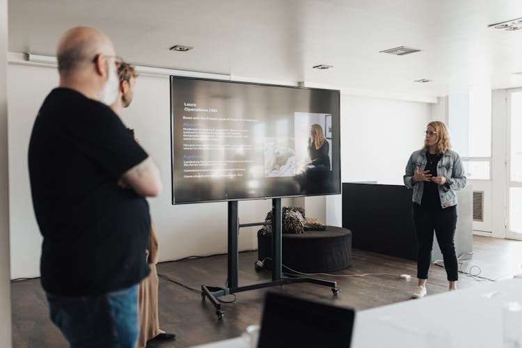 Standing Woman Presenting In Meeting