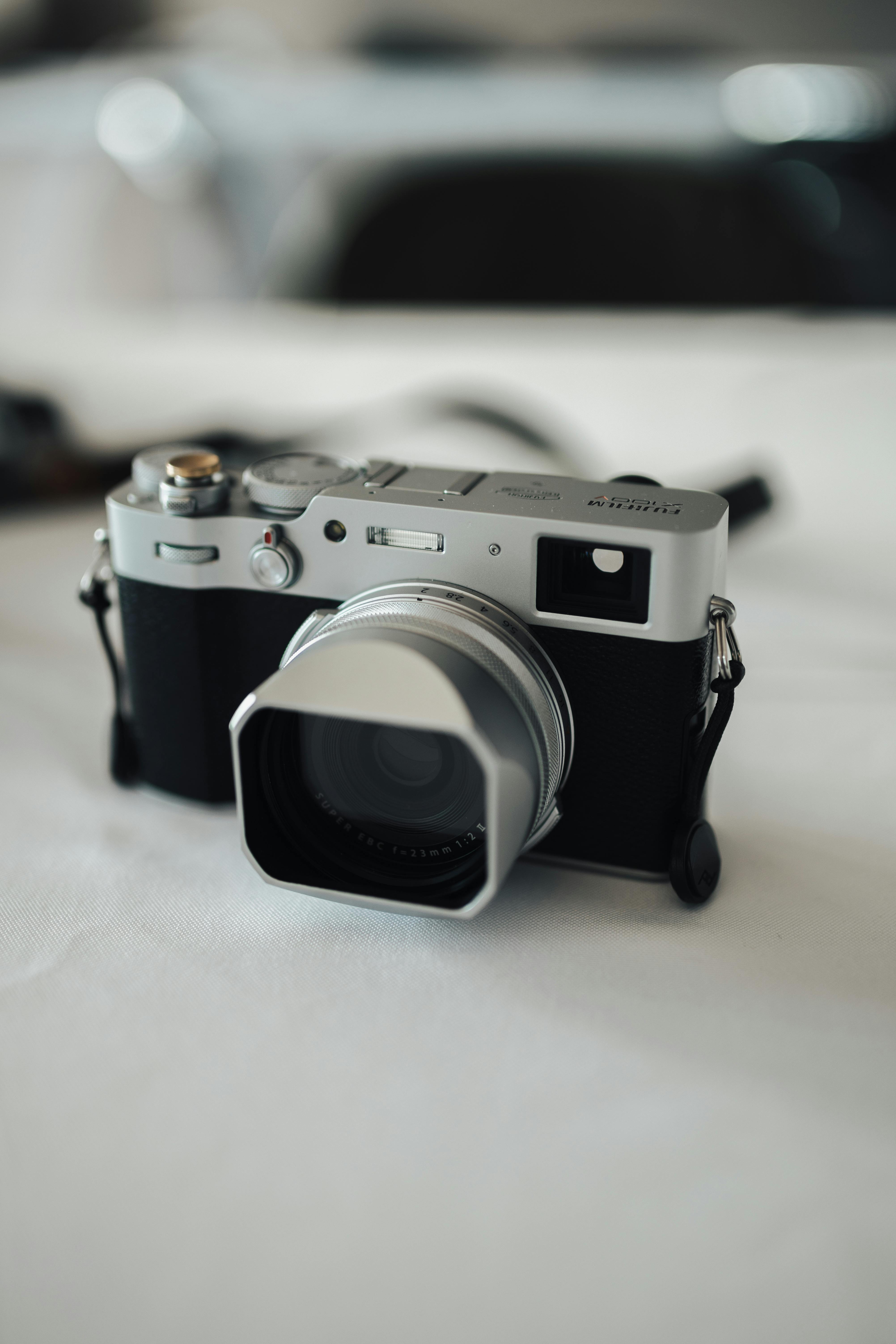 a silver camera sitting on a white table