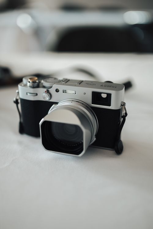 Free Close-up of a classic vintage camera with a large lens hood on a white table. Stock Photo