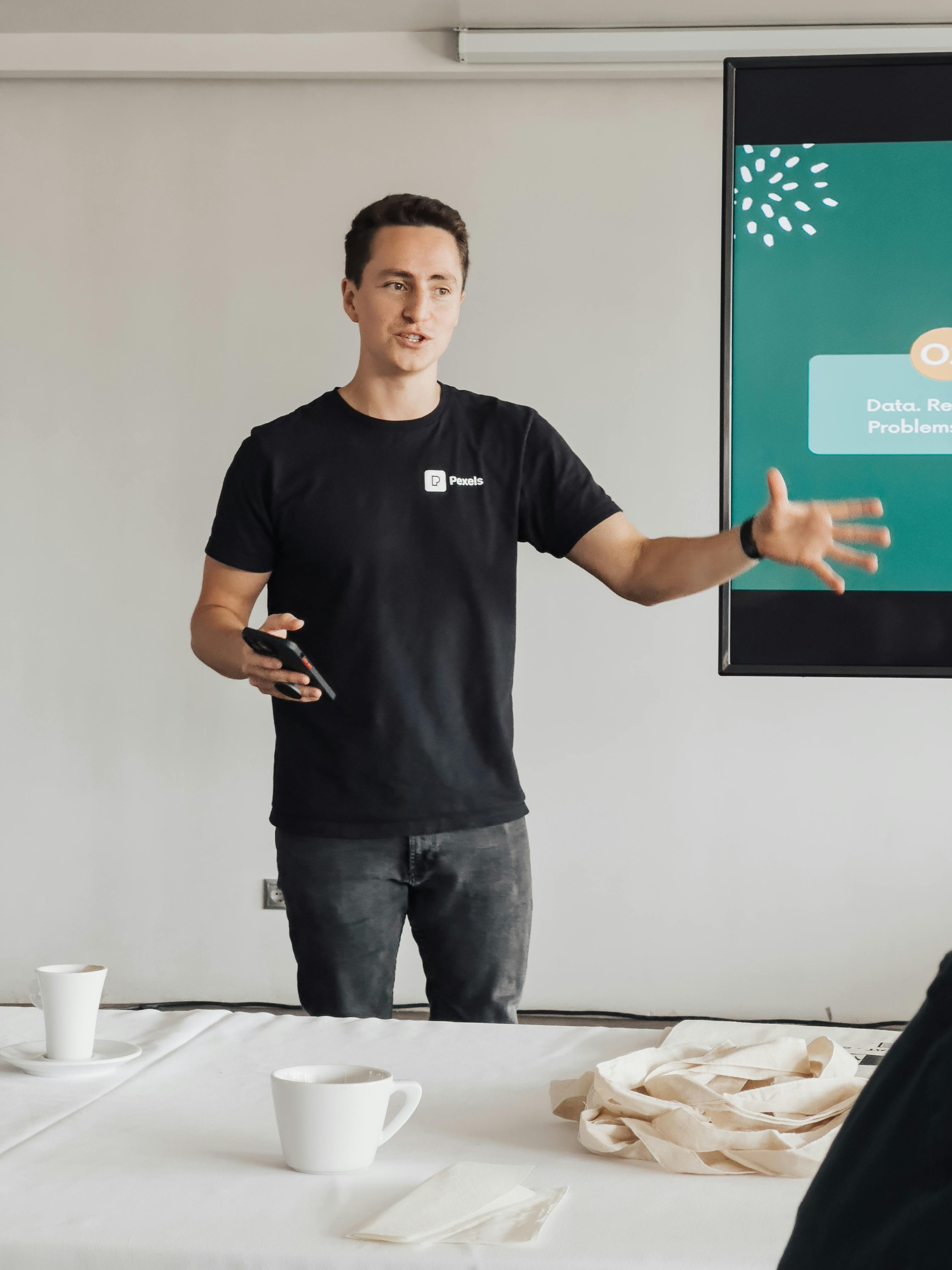 Young man conducting a business presentation in a modern office environment. Engaged and professional.