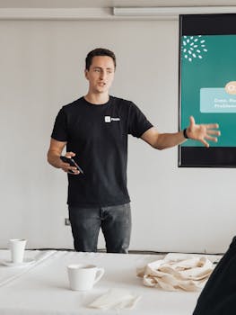 Young man conducting a business presentation in a modern office environment. Engaged and professional.