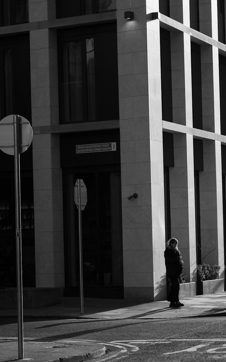 Person Standing Near A Building With Columns