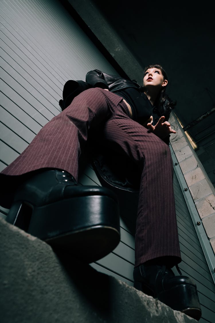 Low Angle Shot Of A Woman Standing On A Ledge