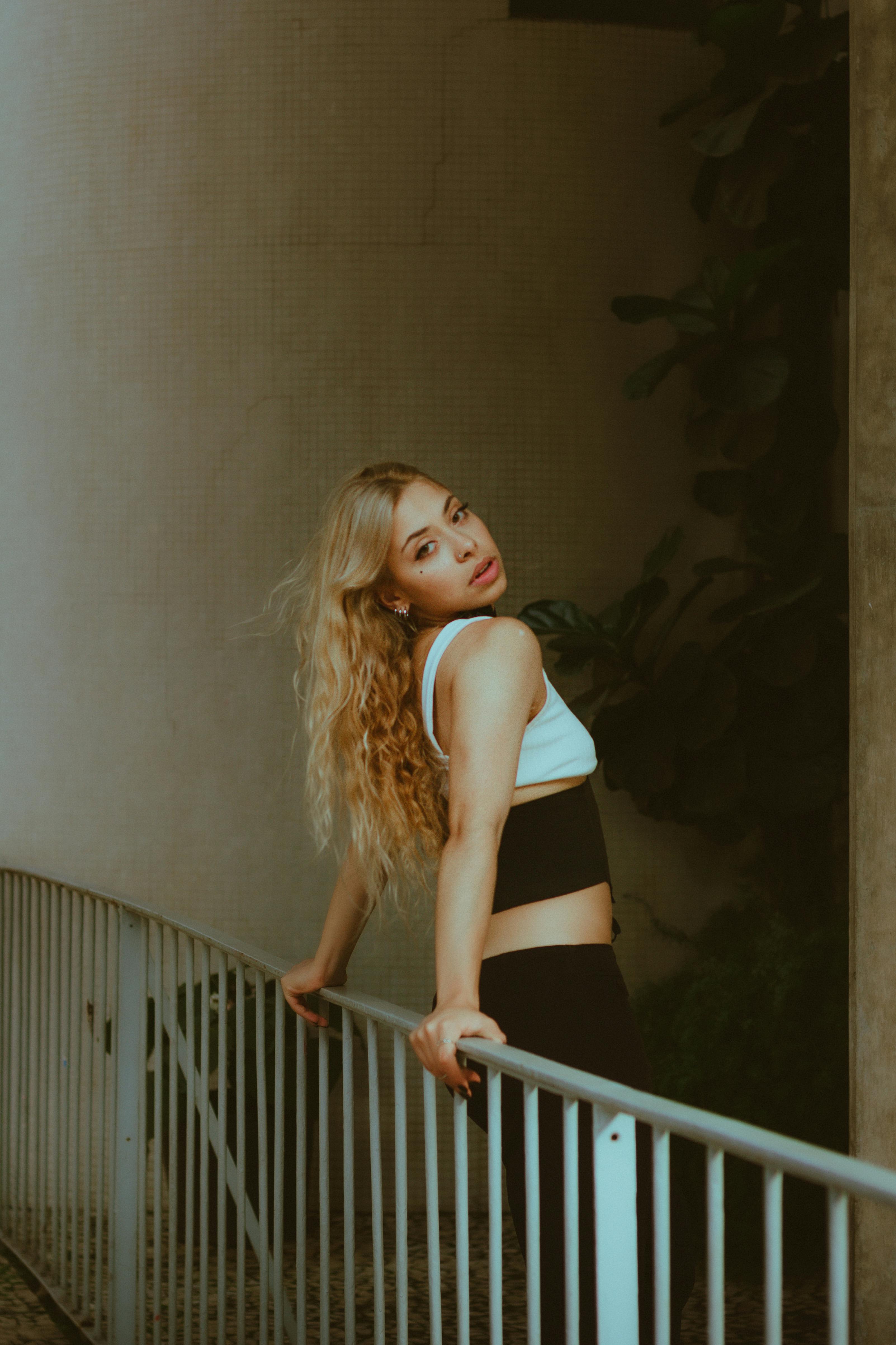 young woman leaning against the railing