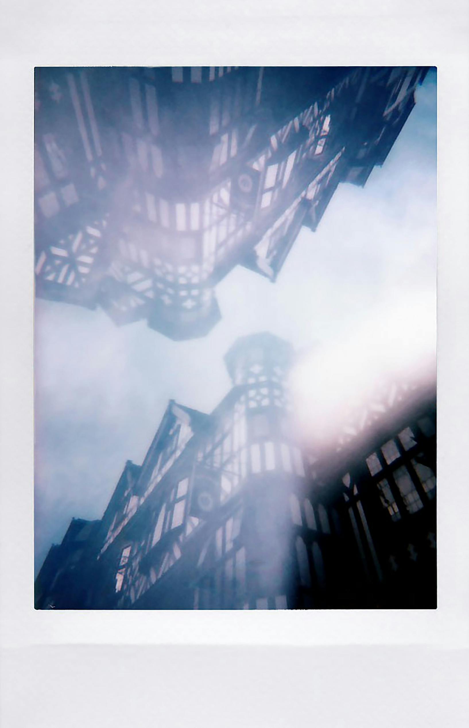 Tudor architecture reflected on a surface creates a mystic urban scene.