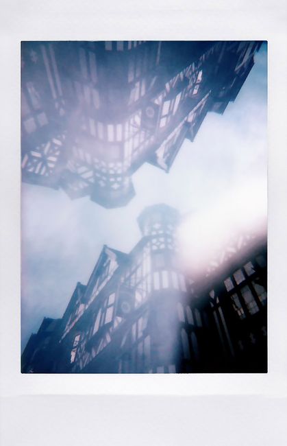 Tudor architecture reflected on a surface creates a mystic urban scene.