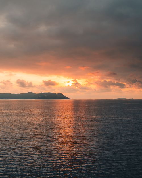 Free Stunning sunset view over the tranquil sea in Kaş, Antalya, Turkey, with vibrant colors and cloud formations. Stock Photo