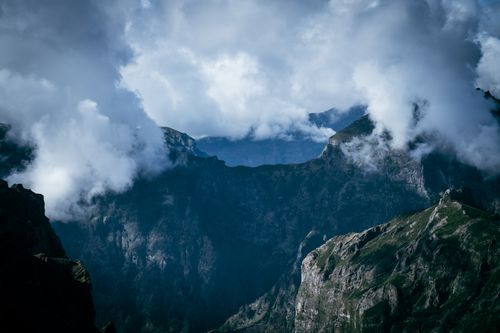 Free A breathtaking view of rugged mountain peaks shrouded in clouds, capturing nature's grandeur. Stock Photo