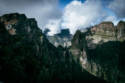 Free Majestic mountain peaks shrouded in clouds, capturing the raw beauty of nature. Stock Photo