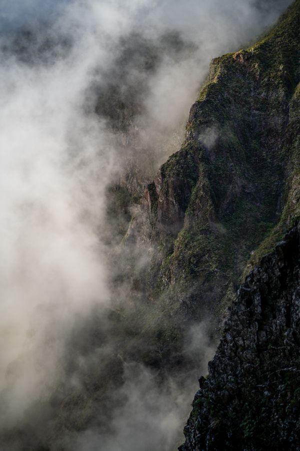 Cliff face wrapped in mist — photo by Artem Zhukov on Pexels