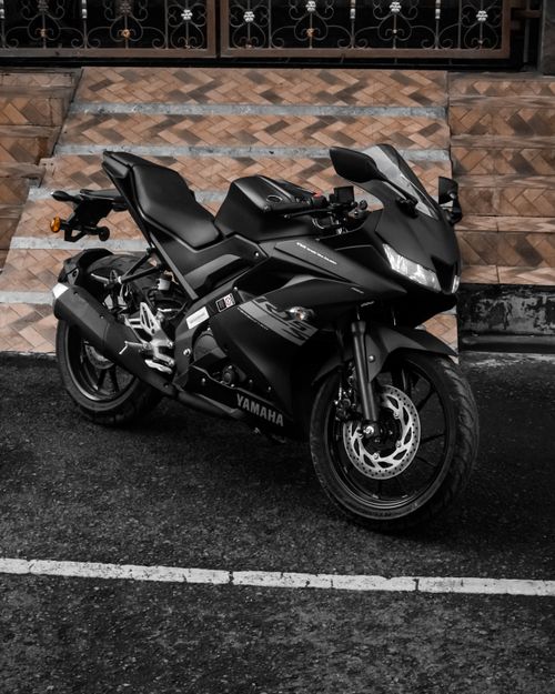 Free Shot of a sleek black Yamaha sport motorcycle parked on an urban street. Stock Photo