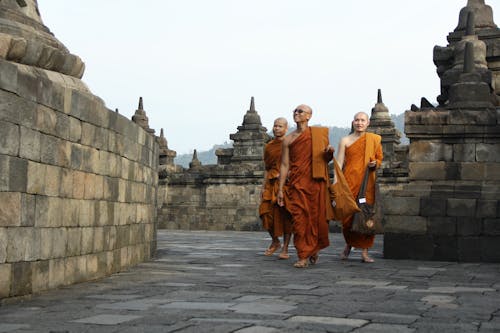 Buddhist Monks Walking around Temple Walls