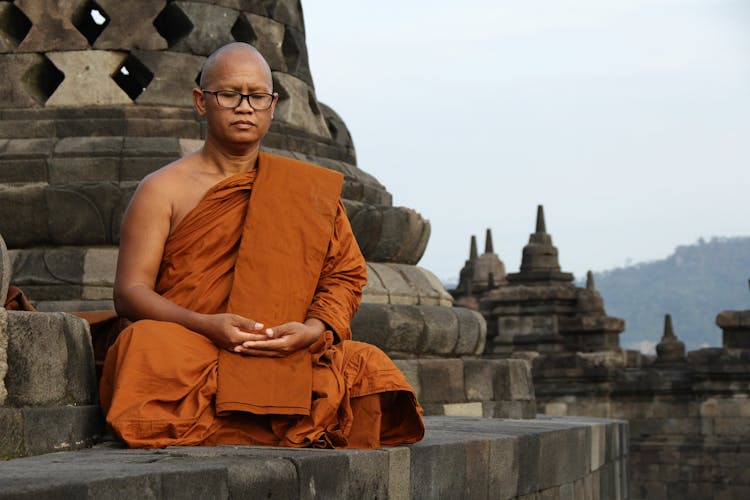 Buddhist Monk Sitting And Meditating